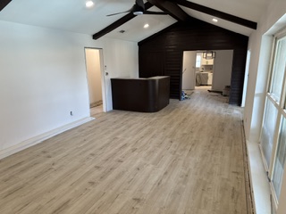 Finished kitchen with white shaker cabinets and marble backsplash