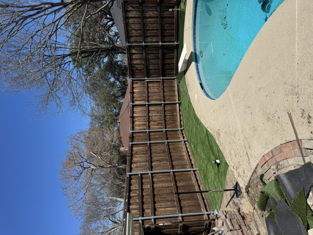 Backyard with new turf installed around pool